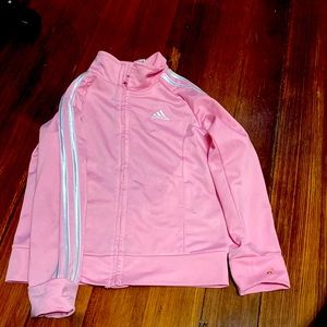 Pink sweater brand Adidas.